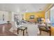 Spacious living room with comfortable seating, a decorative accent wall, and bright, natural lighting at 42808 W Whimsical Dr, Maricopa, AZ 85138