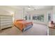 Bright main bedroom featuring a canopy bed, carpet flooring, and large windows with natural light at 42808 W Whimsical Dr, Maricopa, AZ 85138