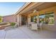 Covered patio with a ceiling fan and outdoor seating; ideal for relaxing or entertaining guests at 42808 W Whimsical Dr, Maricopa, AZ 85138