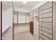 Walk-in closet with custom shelving and storage solutions, providing ample space at 42808 W Whimsical Dr, Maricopa, AZ 85138