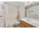 Standard bathroom with a tub/shower combination, white tile surround, and light wood vanity with sink at 4610 N 68Th St # 402, Scottsdale, AZ 85251