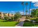 Beautifully landscaped community grounds feature lush green lawns, a community pool, and mature palm trees at 4610 N 68Th St # 402, Scottsdale, AZ 85251