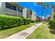 Exterior view of a condo complex featuring palm trees, well-maintained lawns, and manicured shrubbery at 4610 N 68Th St # 402, Scottsdale, AZ 85251