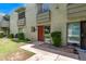 Inviting exterior view of a two-story home with a well-maintained lawn and desert landscaping at 4610 N 68Th St # 402, Scottsdale, AZ 85251
