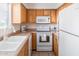 Functional kitchen featuring ample cabinetry, a white refrigerator, and a stainless steel oven and microwave at 4610 N 68Th St # 402, Scottsdale, AZ 85251