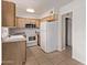 Functional kitchen equipped with white appliances, wood cabinets, and ample countertop space at 4610 N 68Th St # 402, Scottsdale, AZ 85251