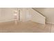Open-concept living room with tiled floors seamlessly connects to the kitchen and staircase at 4610 N 68Th St # 402, Scottsdale, AZ 85251