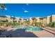 Community pool surrounded by lounge chairs, landscaping and building exteriors is ready for residents to enjoy at 4610 N 68Th St # 402, Scottsdale, AZ 85251