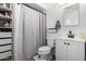 Compact bathroom features functional storage and a shower/tub combination at 4749 W Beverly Ln, Glendale, AZ 85306