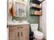 Well-lit bathroom showcases a modern vanity, gold fixtures, and decorative shelving at 4749 W Beverly Ln, Glendale, AZ 85306