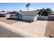 Inviting single-Gathering home featuring a lush green lawn and a spacious two-car garage at 4749 W Beverly Ln, Glendale, AZ 85306