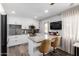 Bright kitchen with granite counters, an island with bar seating, and stainless steel appliances at 4749 W Beverly Ln, Glendale, AZ 85306