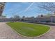 Artificial turf area in a backyard featuring decorative gravel and a block wall at 4815 E Kiva St, Phoenix, AZ 85044