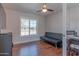 Relaxing room with wood floors, futon, and large window to let in light at 4815 E Kiva St, Phoenix, AZ 85044