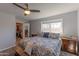 Comfortable main bedroom featuring a ceiling fan, large window, and a walk-in closet at 4815 E Kiva St, Phoenix, AZ 85044