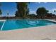 Outdoor swimming pool with lane markers and surrounding greenery at 4815 E Kiva St, Phoenix, AZ 85044