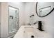 Bright bathroom featuring a sleek white sink, black hardware, and a tiled walk-in shower at 529 S Val Vista Rd, Apache Junction, AZ 85119