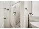 Bright bathroom featuring white marble walls, black hardware, and a shower with patterned floors at 529 S Val Vista Rd, Apache Junction, AZ 85119