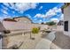 Spacious backyard with gravel landscape, walkway, and block wall for privacy at 6664 W Rose Garden Ln, Glendale, AZ 85308