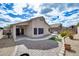 Expansive backyard with covered patio, brick-paved sections, and mature desert landscaping at 6664 W Rose Garden Ln, Glendale, AZ 85308