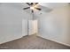 Bedroom with a ceiling fan, neutral carpet, and a large closet at 6664 W Rose Garden Ln, Glendale, AZ 85308