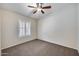 Bedroom with shuttered window and ceiling fan at 6664 W Rose Garden Ln, Glendale, AZ 85308