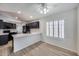 Dining area with wood floors, a modern ceiling fan, and black kitchen appliances in view at 6664 W Rose Garden Ln, Glendale, AZ 85308