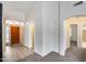 Bright foyer with wood-look tile flooring, arched doorways, and a wood door with glass pane windows at 6664 W Rose Garden Ln, Glendale, AZ 85308