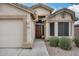 Close up of front door featuring a charming wooden door and desert landscaping at 6664 W Rose Garden Ln, Glendale, AZ 85308