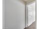 Neutral hallway featuring a white door and neutral carpet at 6664 W Rose Garden Ln, Glendale, AZ 85308