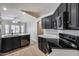 Well-equipped kitchen with black appliances, quartz counters, and open design at 6664 W Rose Garden Ln, Glendale, AZ 85308