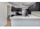 Contemporary kitchen featuring black cabinetry, stainless appliances, and elegant quartz countertops at 6664 W Rose Garden Ln, Glendale, AZ 85308