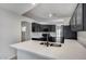 Stylish kitchen with black cabinets, a stainless steel sink, and beautiful quartz countertops at 6664 W Rose Garden Ln, Glendale, AZ 85308