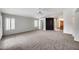 Spacious living room with neutral carpet, ceiling fan, and an accent wall at 6664 W Rose Garden Ln, Glendale, AZ 85308