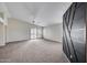 Spacious living room with new carpet, vaulted ceiling, and plentiful natural light at 6664 W Rose Garden Ln, Glendale, AZ 85308