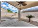 Covered patio with ceiling fan, complemented by desert landscaping and paver accents at 6664 W Rose Garden Ln, Glendale, AZ 85308