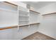 Neat walk-in closet with shelving and closet rods at 6664 W Rose Garden Ln, Glendale, AZ 85308