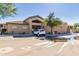 Exterior view of the clubhouse and parking area on a sunny day at 705 W Queen Creek Rd # 1059, Chandler, AZ 85248