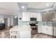 Modern kitchen with stainless steel appliances, white cabinets, and eye-catching tile backsplash at 705 W Queen Creek Rd # 1059, Chandler, AZ 85248