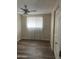 This bedroom features a ceiling fan, window with blinds, and wood-look flooring at 730 E Dobbins Rd, Phoenix, AZ 85042