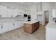 Bright kitchen features white cabinets, stainless steel appliances, and a wood island at 740 W Patrick Pl, San Tan Valley, AZ 85143