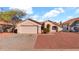 Single story home with desert landscaping, garage and a well maintained front yard at 9230 W Charleston Ave, Peoria, AZ 85382