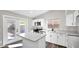 Modern white kitchen with stainless steel appliances and a center island with a quartz countertop at 9230 W Charleston Ave, Peoria, AZ 85382