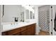 Well-lit bathroom featuring a double vanity, mirrors, and a separate shower with patterned curtains at 9282 E Desert Vw, Scottsdale, AZ 85255