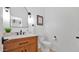 Elegant powder room with a stylish wood vanity, marble countertop, and modern black fixtures at 9282 E Desert Vw, Scottsdale, AZ 85255