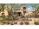 Stone home with an outdoor sitting area and mature landscaping at 9282 E Desert Vw, Scottsdale, AZ 85255