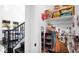 Well-organized hallway closet with shelving, shoe storage, and a glimpse into the playroom at 9282 E Desert Vw, Scottsdale, AZ 85255