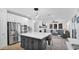 Open concept kitchen with stainless appliances, white cabinets, and view into the living room at 9282 E Desert Vw, Scottsdale, AZ 85255