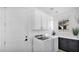 Modern laundry room with white cabinets and washer and dryer at 9282 E Desert Vw, Scottsdale, AZ 85255