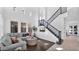 Bright living room with high ceilings, large windows, hardwood floors, and a staircase at 9282 E Desert Vw, Scottsdale, AZ 85255